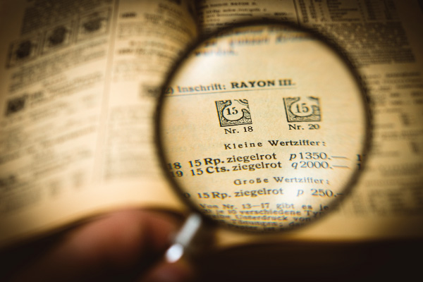 Looking at a book through magnifying glass