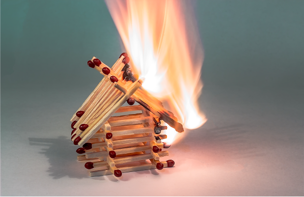 Matches stacked in shape of house, begining to burn fast