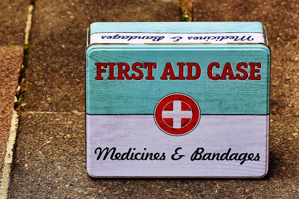 Old first aid and medicine tin on slab floor