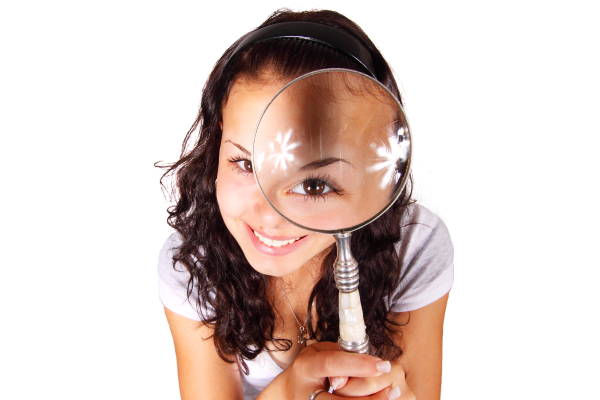 Girl looking at you through magnifying glass