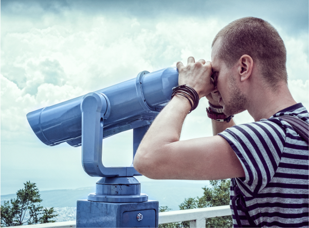 Man looking through telescope